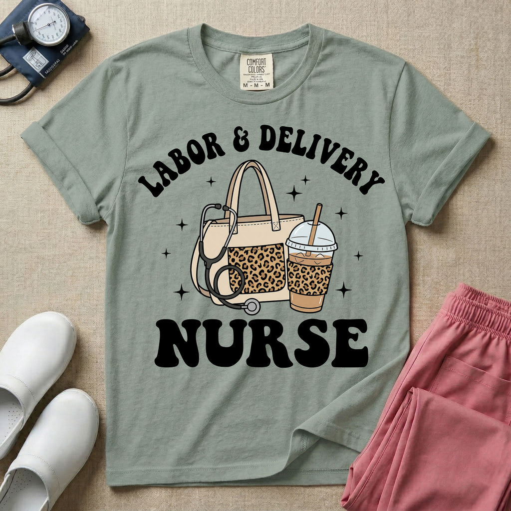 A Labor and Delivery nurse graphic featuring a large beige tote bag with a leopard print pocket, a stethoscope draped over it, and a large iced coffee cup with a matching leopard print sleeve, all surrounded by white text that reads LABOR & DELIVERY curved above and NURSE below.