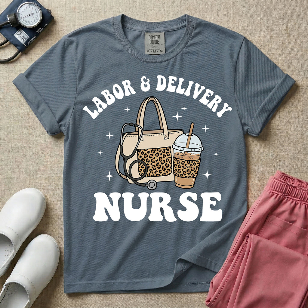 A Labor and Delivery nurse graphic featuring a large beige tote bag with a leopard print pocket, a stethoscope draped over it, and a large iced coffee cup with a matching leopard print sleeve, all surrounded by white text that reads LABOR & DELIVERY curved above and NURSE below.
