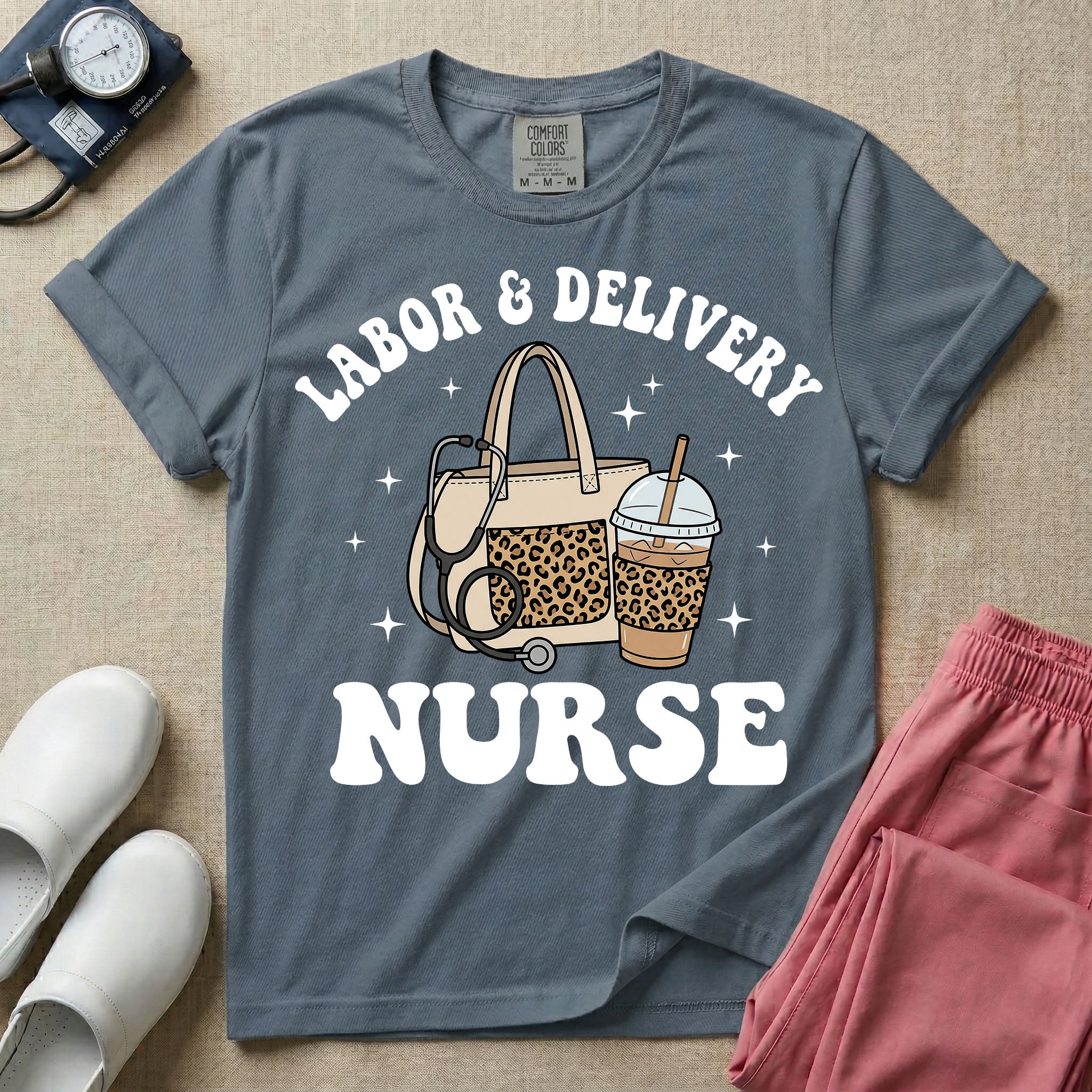 A Labor and Delivery nurse graphic featuring a large beige tote bag with a leopard print pocket, a stethoscope draped over it, and a large iced coffee cup with a matching leopard print sleeve, all surrounded by white text that reads LABOR & DELIVERY curved above and NURSE below.