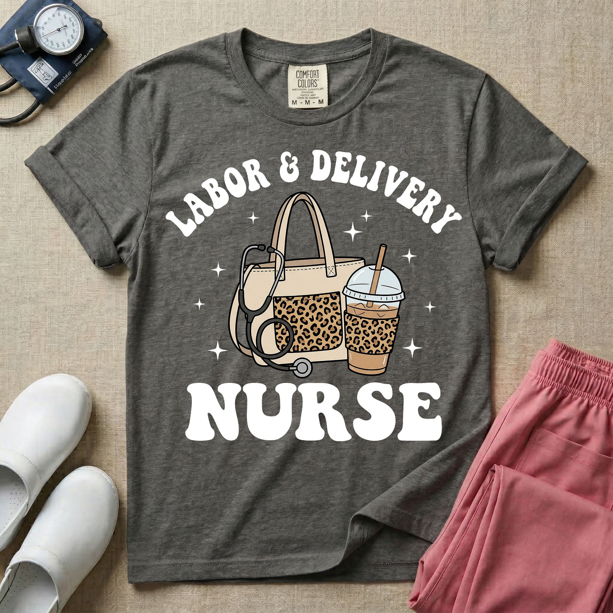 A Labor and Delivery nurse graphic featuring a large beige tote bag with a leopard print pocket, a stethoscope draped over it, and a large iced coffee cup with a matching leopard print sleeve, all surrounded by white text that reads LABOR & DELIVERY curved above and NURSE below.