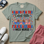A cute Neonatal Intensive Care Unit nurse graphic featuring a row of diverse babies wrapped in patriotic red, white, and blue star-spangled and striped swaddles, with some wearing top hats, surrounded by fireworks and star bunting, alongside retro text reading CARING FOR THE Cutest little FIRECRACKERS NICU NURSE.