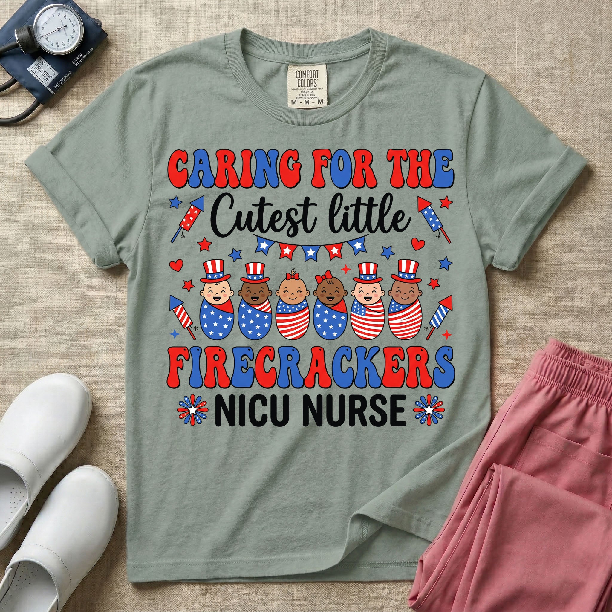 A cute Neonatal Intensive Care Unit nurse graphic featuring a row of diverse babies wrapped in patriotic red, white, and blue star-spangled and striped swaddles, with some wearing top hats, surrounded by fireworks and star bunting, alongside retro text reading CARING FOR THE Cutest little FIRECRACKERS NICU NURSE.