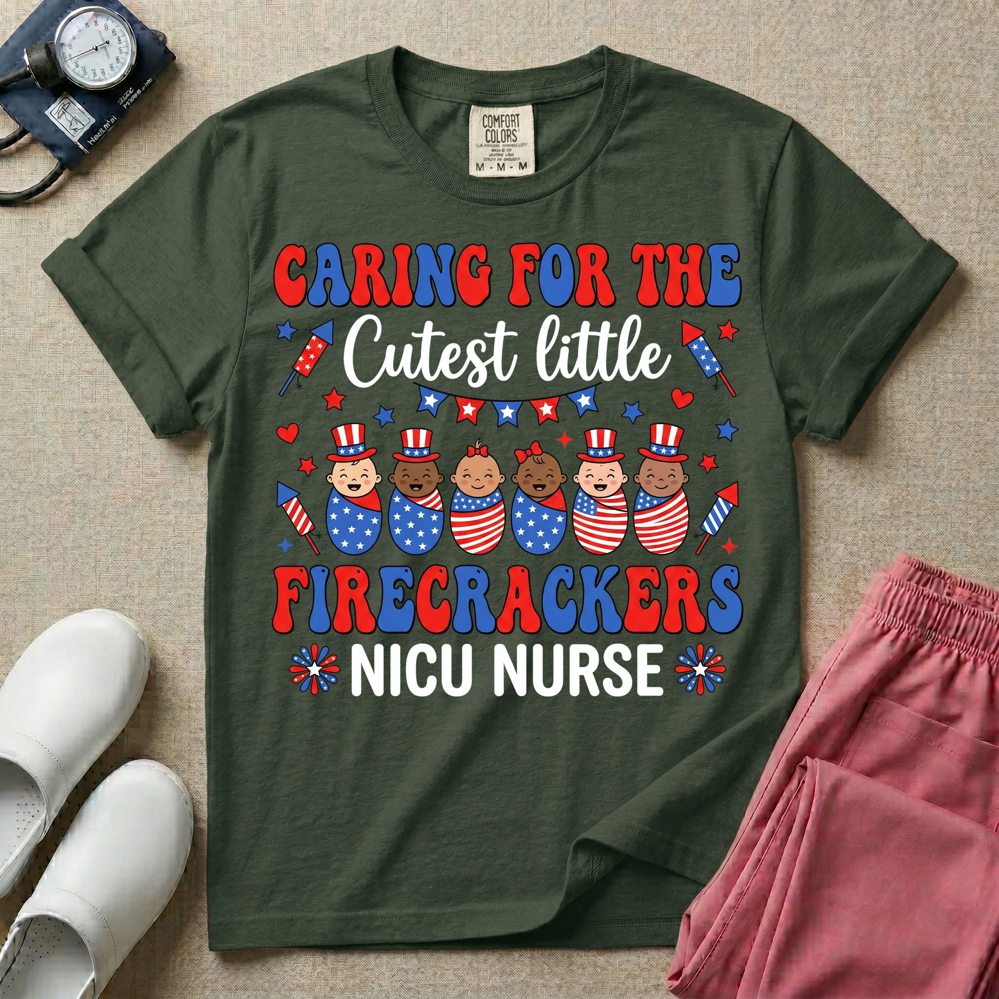 A cute Neonatal Intensive Care Unit nurse graphic featuring a row of diverse babies wrapped in patriotic red, white, and blue star-spangled and striped swaddles, with some wearing top hats, surrounded by fireworks and star bunting, alongside retro text reading CARING FOR THE Cutest little FIRECRACKERS NICU NURSE.