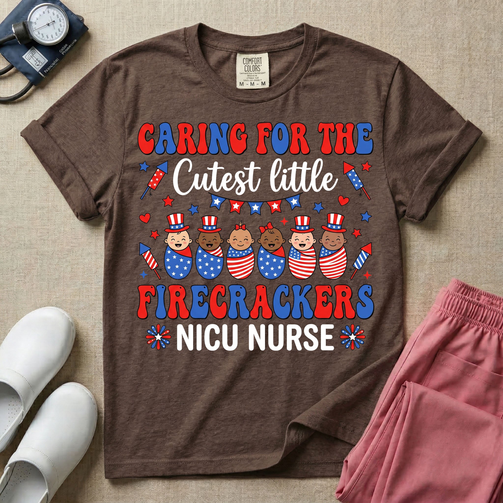 A cute Neonatal Intensive Care Unit nurse graphic featuring a row of diverse babies wrapped in patriotic red, white, and blue star-spangled and striped swaddles, with some wearing top hats, surrounded by fireworks and star bunting, alongside retro text reading CARING FOR THE Cutest little FIRECRACKERS NICU NURSE.