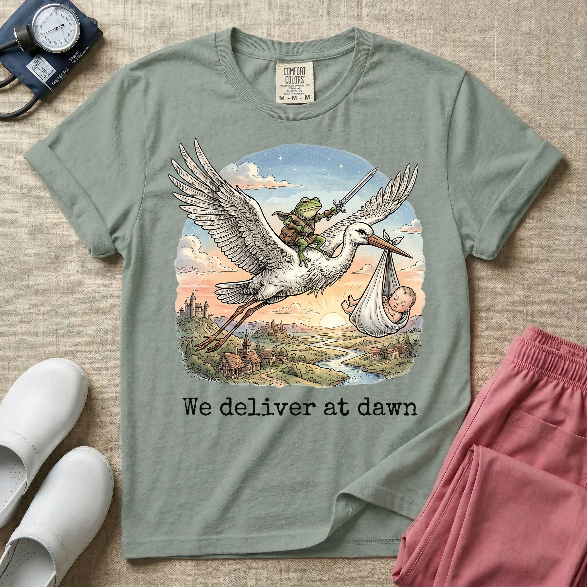 A humorous Labor and Delivery graphic featuring a storybook illustration of a frog dressed as a knight wielding a sword, riding on the back of a flying stork that is carrying a sleeping baby in a bundle, soaring over a fantasy landscape with a castle at sunrise, accompanied by text below that reads We deliver at dawn.