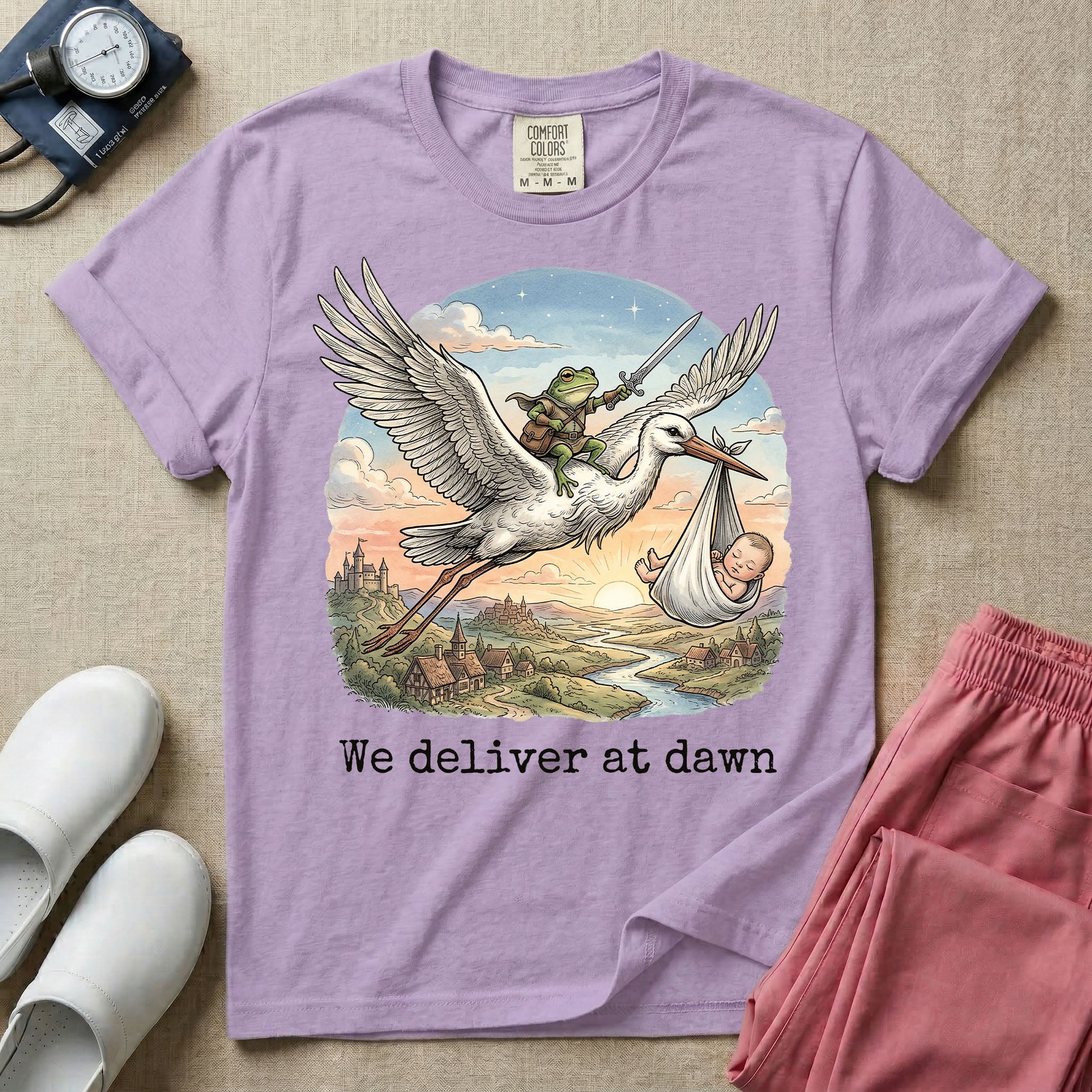 A humorous Labor and Delivery graphic featuring a storybook illustration of a frog dressed as a knight wielding a sword, riding on the back of a flying stork that is carrying a sleeping baby in a bundle, soaring over a fantasy landscape with a castle at sunrise, accompanied by text below that reads We deliver at dawn.