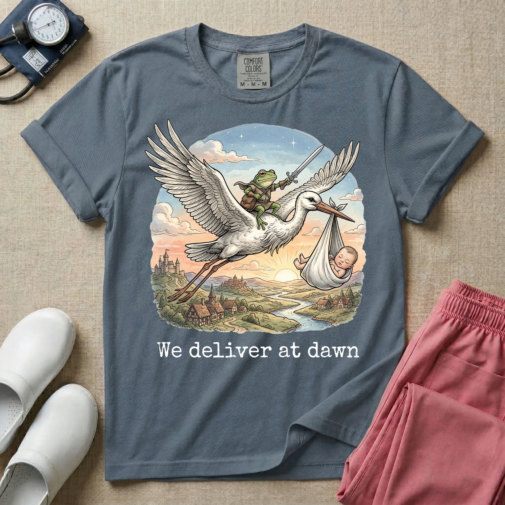 A humorous Labor and Delivery graphic featuring a storybook illustration of a frog dressed as a knight wielding a sword, riding on the back of a flying stork that is carrying a sleeping baby in a bundle, soaring over a fantasy landscape with a castle at sunrise, accompanied by text below that reads We deliver at dawn.