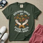 A Labor and Delivery and Doula graphic featuring an illustration of two open hands gently holding a bouquet of wildflowers with a large sunflower at the base, surrounded by white text that reads HOLDING SPACE for above and EVERY BIRTH. EVERY BODY. below.