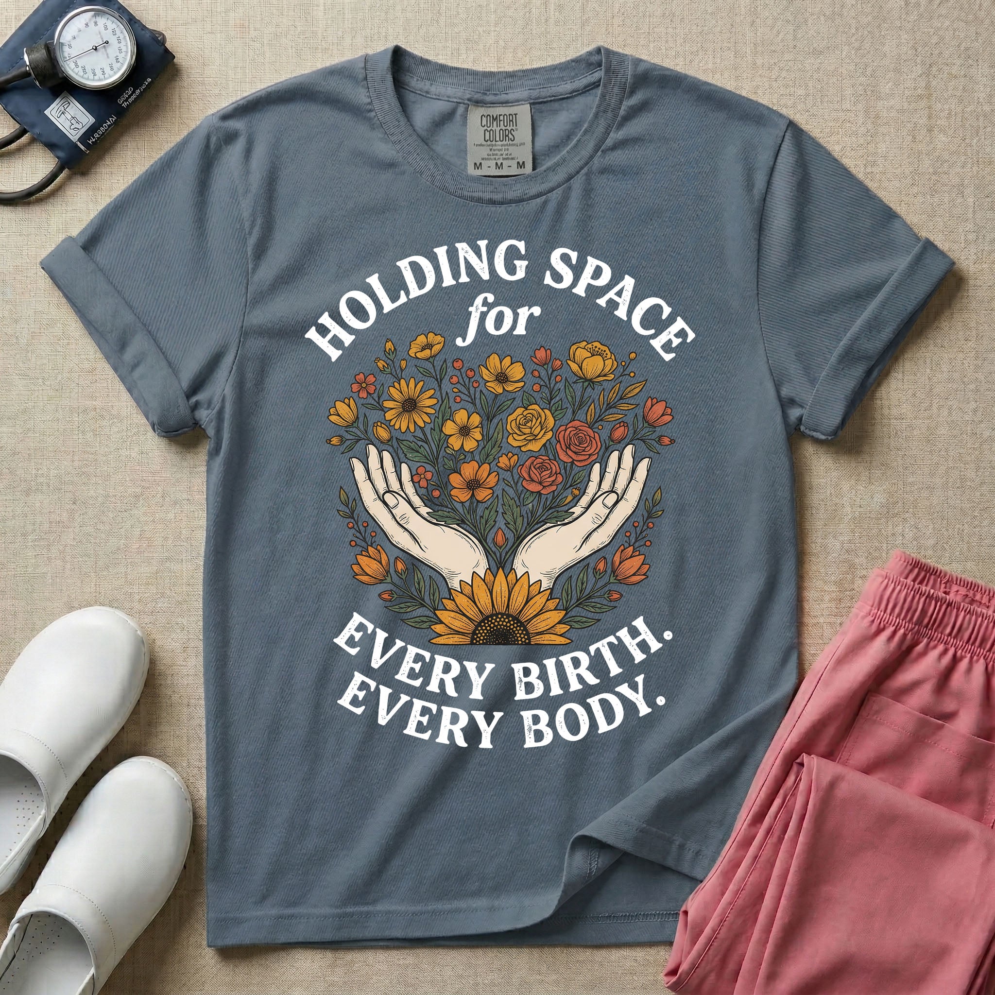 A Labor and Delivery and Doula graphic featuring an illustration of two open hands gently holding a bouquet of wildflowers with a large sunflower at the base, surrounded by white text that reads HOLDING SPACE for above and EVERY BIRTH. EVERY BODY. below.