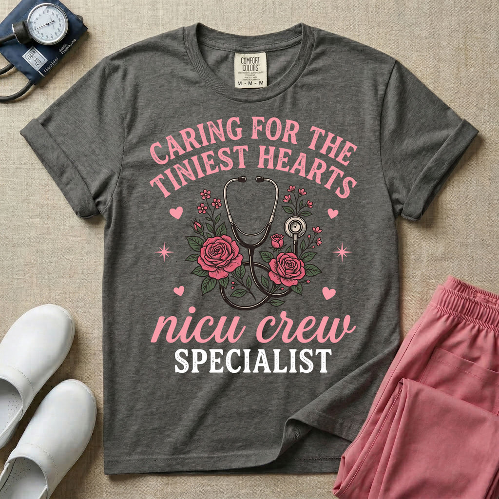 NICU nurse graphic featuring a stethoscope intertwined with pink roses, stars, and hearts, surrounded by the text "Caring for the tiniest hearts nicu crew SPECIALIST".