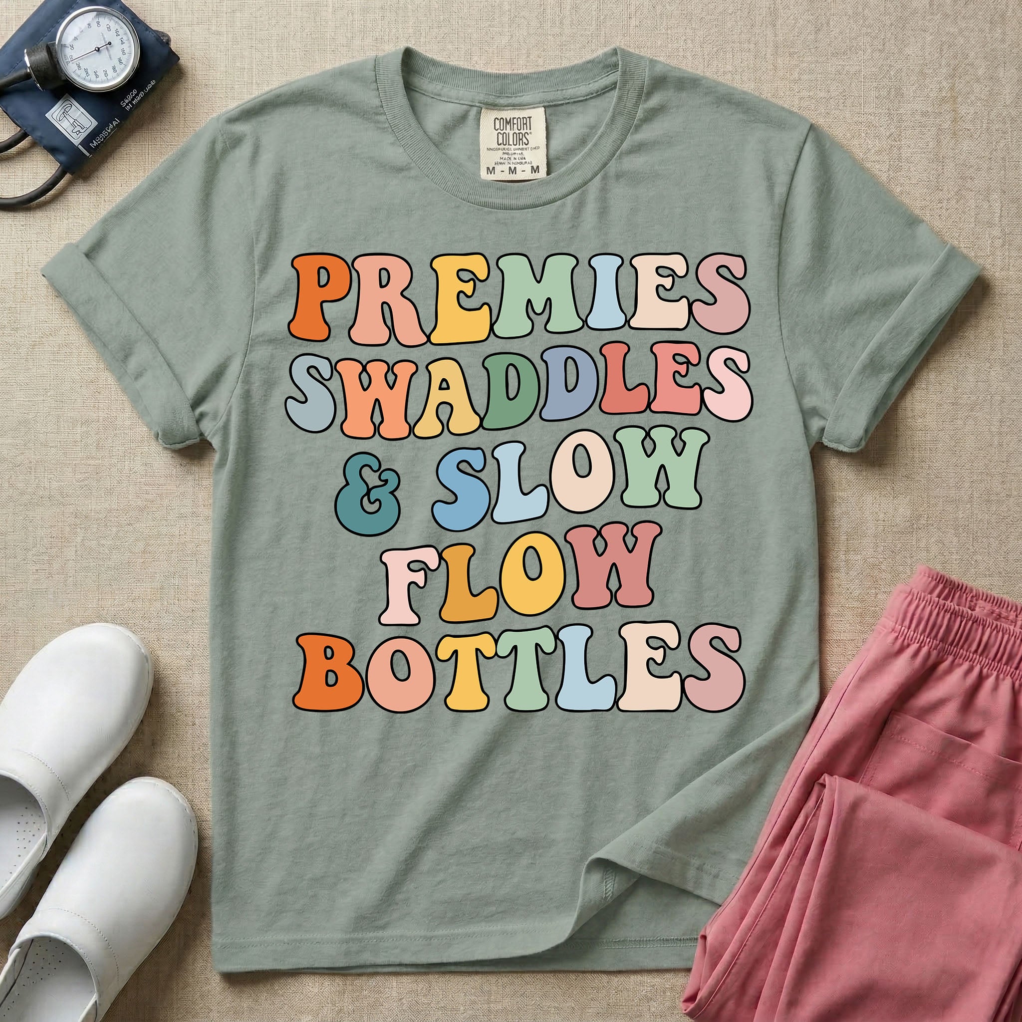 NICU nurse graphic featuring the phrase PREMIES SWADDLES & SLOW FLOW BOTTLES written in colorful retro wavy bubble letters.