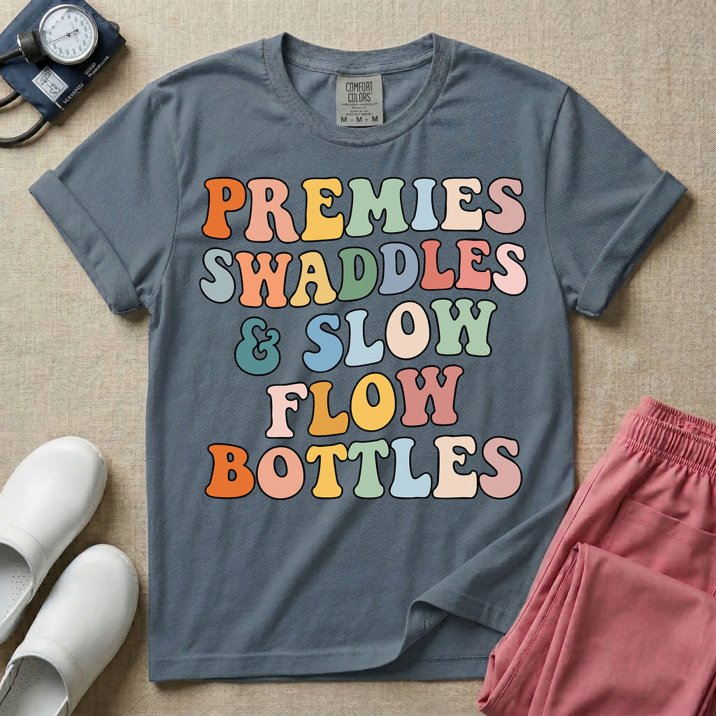 NICU nurse graphic featuring the phrase PREMIES SWADDLES & SLOW FLOW BOTTLES written in colorful retro wavy bubble letters.