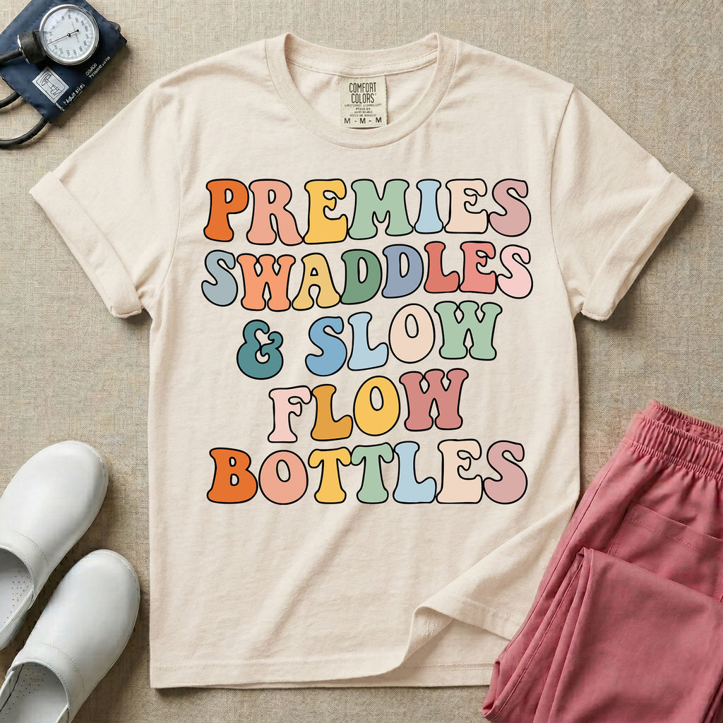 NICU nurse graphic featuring the phrase PREMIES SWADDLES & SLOW FLOW BOTTLES written in colorful retro wavy bubble letters.