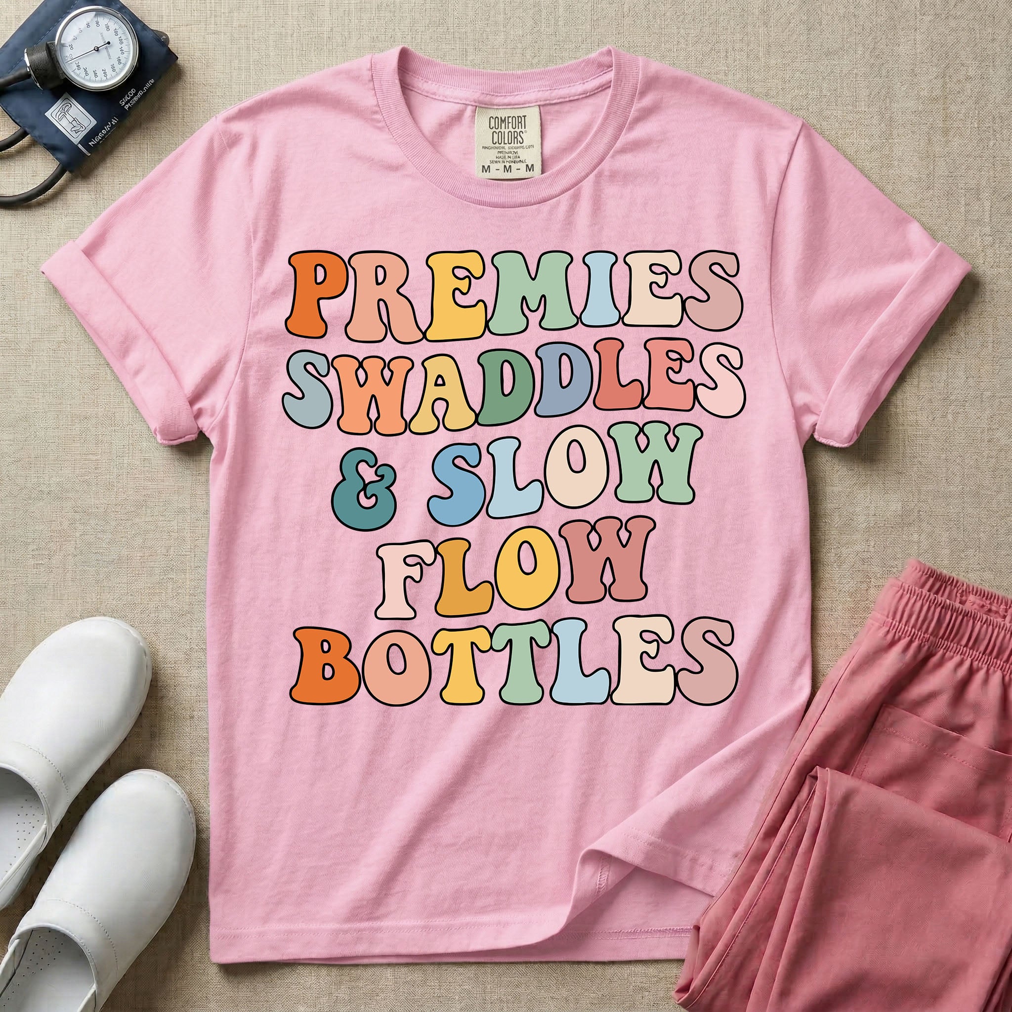 NICU nurse graphic featuring the phrase PREMIES SWADDLES & SLOW FLOW BOTTLES written in colorful retro wavy bubble letters.