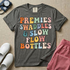 NICU nurse graphic featuring the phrase PREMIES SWADDLES & SLOW FLOW BOTTLES written in colorful retro wavy bubble letters.