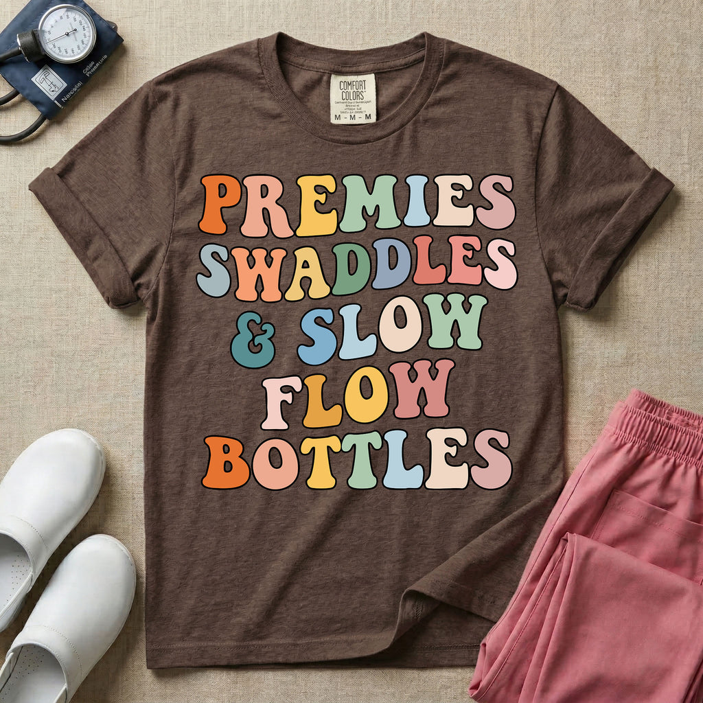 NICU nurse graphic featuring the phrase PREMIES SWADDLES & SLOW FLOW BOTTLES written in colorful retro wavy bubble letters.