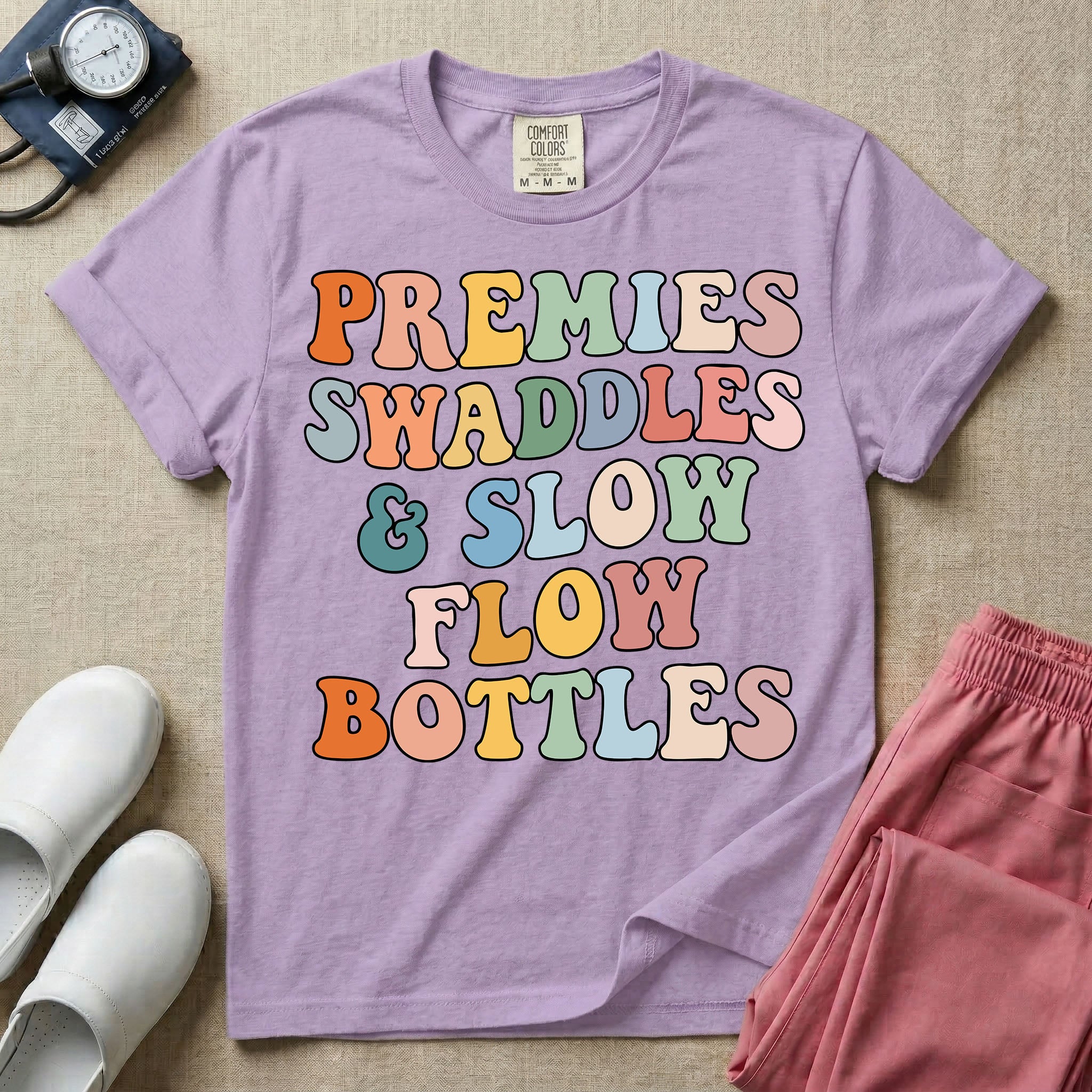NICU nurse graphic featuring the phrase PREMIES SWADDLES & SLOW FLOW BOTTLES written in colorful retro wavy bubble letters.
