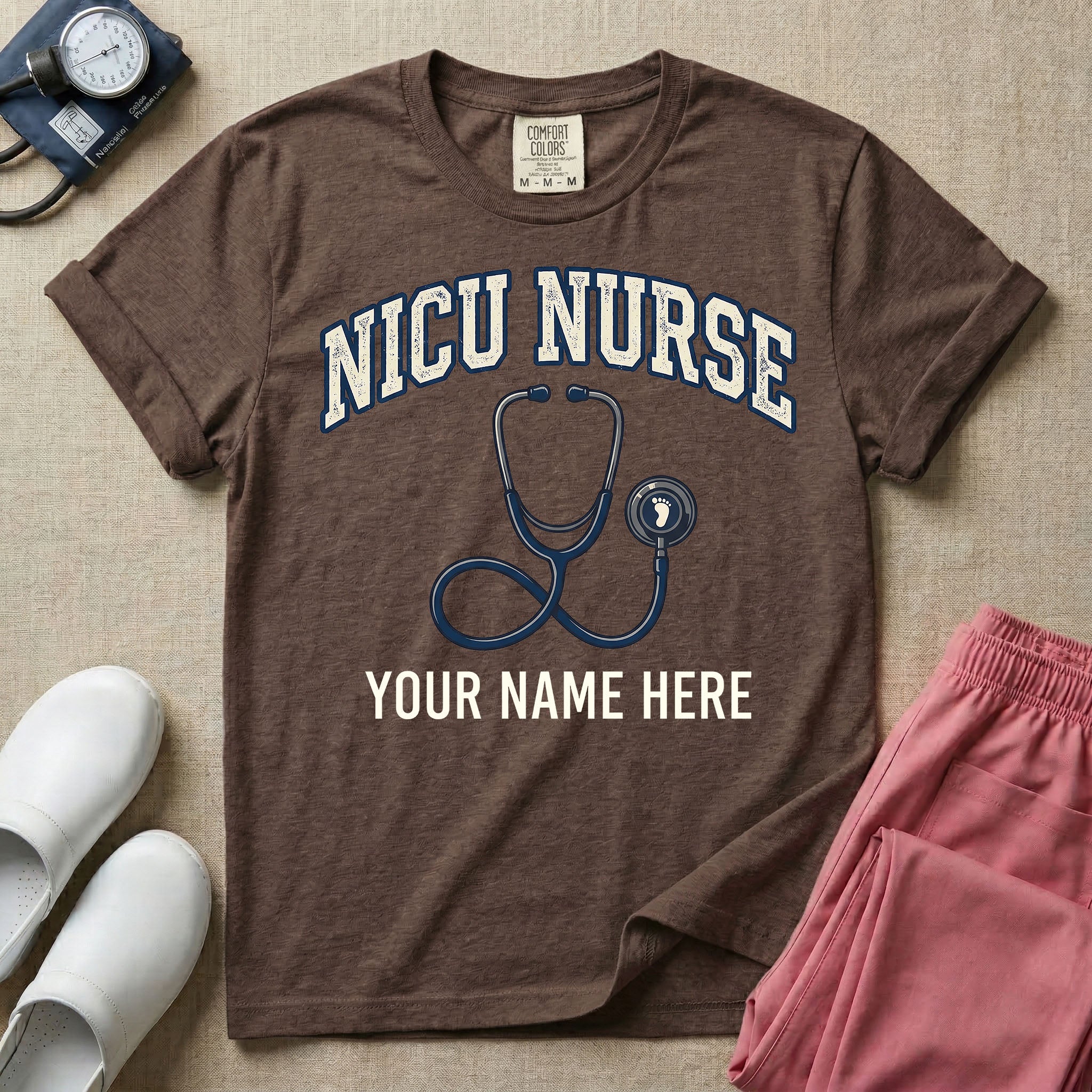 NICU nurse graphic featuring the collegiate text NICU NURSE arched over a stethoscope with a baby footprint on the bell, with the text YOUR NAME HERE at the bottom for custom personalization.