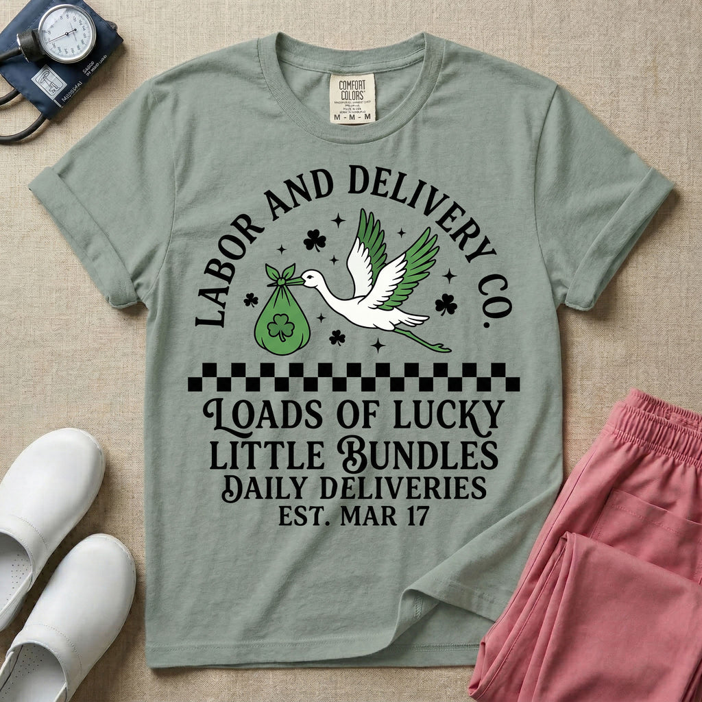 A retro Labor and Delivery nurse design featuring a flying stork carrying a sack with a shamrock, surrounded by stars and clovers, above a checkered border and the text "Labor and Delivery Co. Loads Of Lucky Little Bundles Daily Deliveries Est. Mar 17".