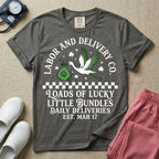 A retro Labor and Delivery nurse design featuring a flying stork carrying a sack with a shamrock, surrounded by stars and clovers, above a checkered border and the text "Labor and Delivery Co. Loads Of Lucky Little Bundles Daily Deliveries Est. Mar 17".