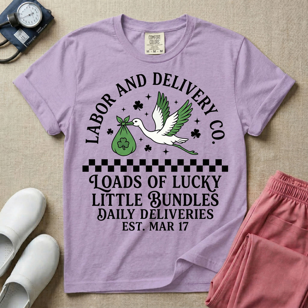 A retro Labor and Delivery nurse design featuring a flying stork carrying a sack with a shamrock, surrounded by stars and clovers, above a checkered border and the text "Labor and Delivery Co. Loads Of Lucky Little Bundles Daily Deliveries Est. Mar 17".