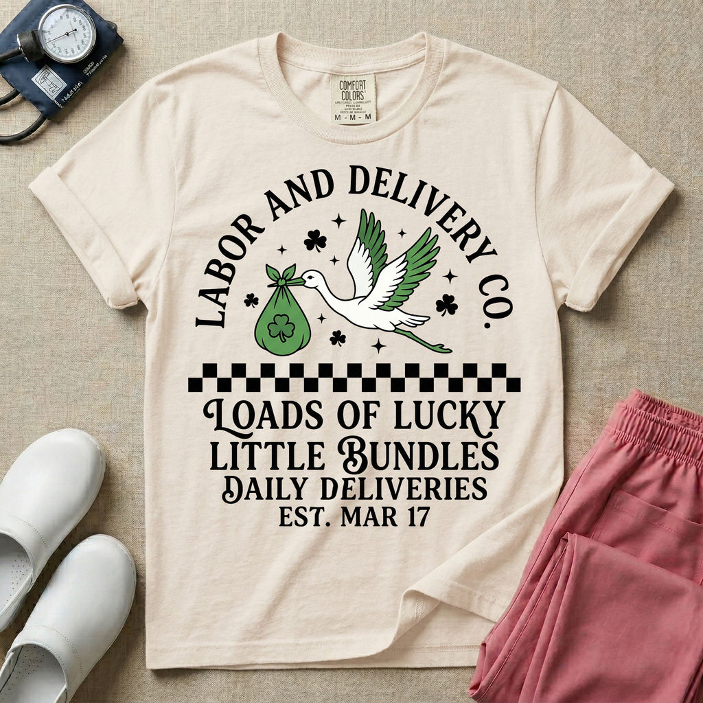 A retro Labor and Delivery nurse design featuring a flying stork carrying a sack with a shamrock, surrounded by stars and clovers, above a checkered border and the text "Labor and Delivery Co. Loads Of Lucky Little Bundles Daily Deliveries Est. Mar 17".