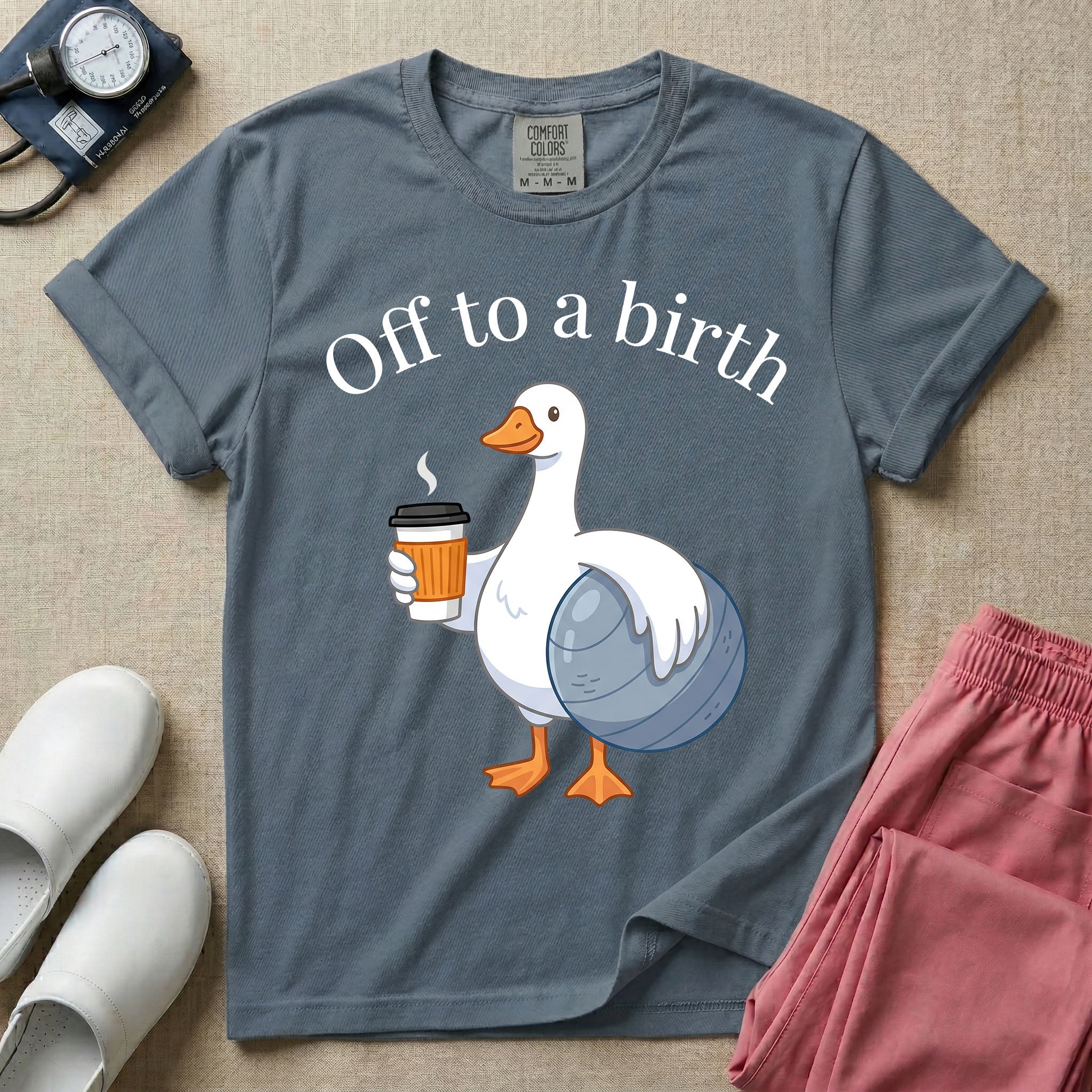 A humorous Labor and Delivery, Midwife, or Doula design featuring a cute cartoon white duck holding a steaming coffee cup and a birthing ball beneath the text "Off to a birth".