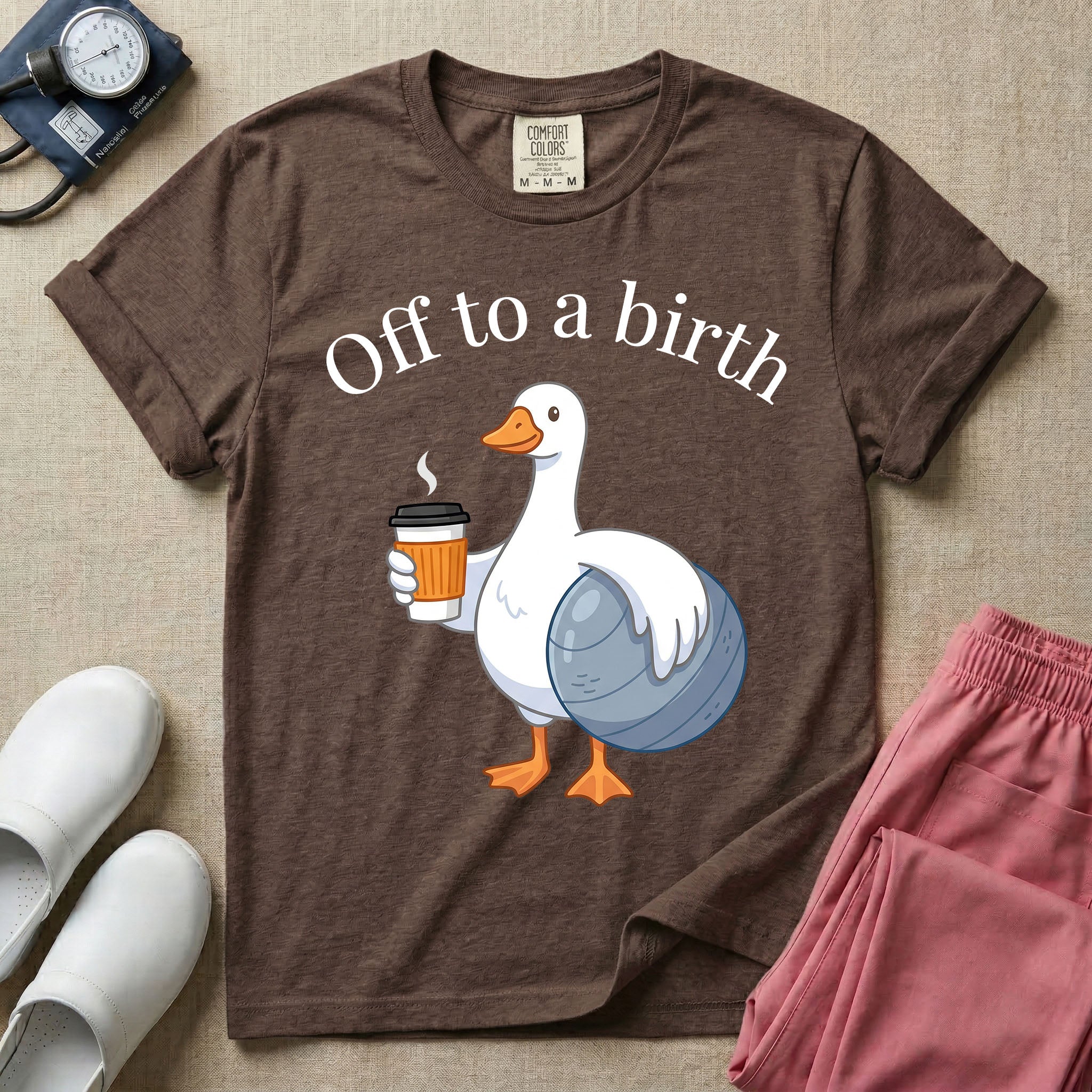 A humorous Labor and Delivery, Midwife, or Doula design featuring a cute cartoon white duck holding a steaming coffee cup and a birthing ball beneath the text "Off to a birth".