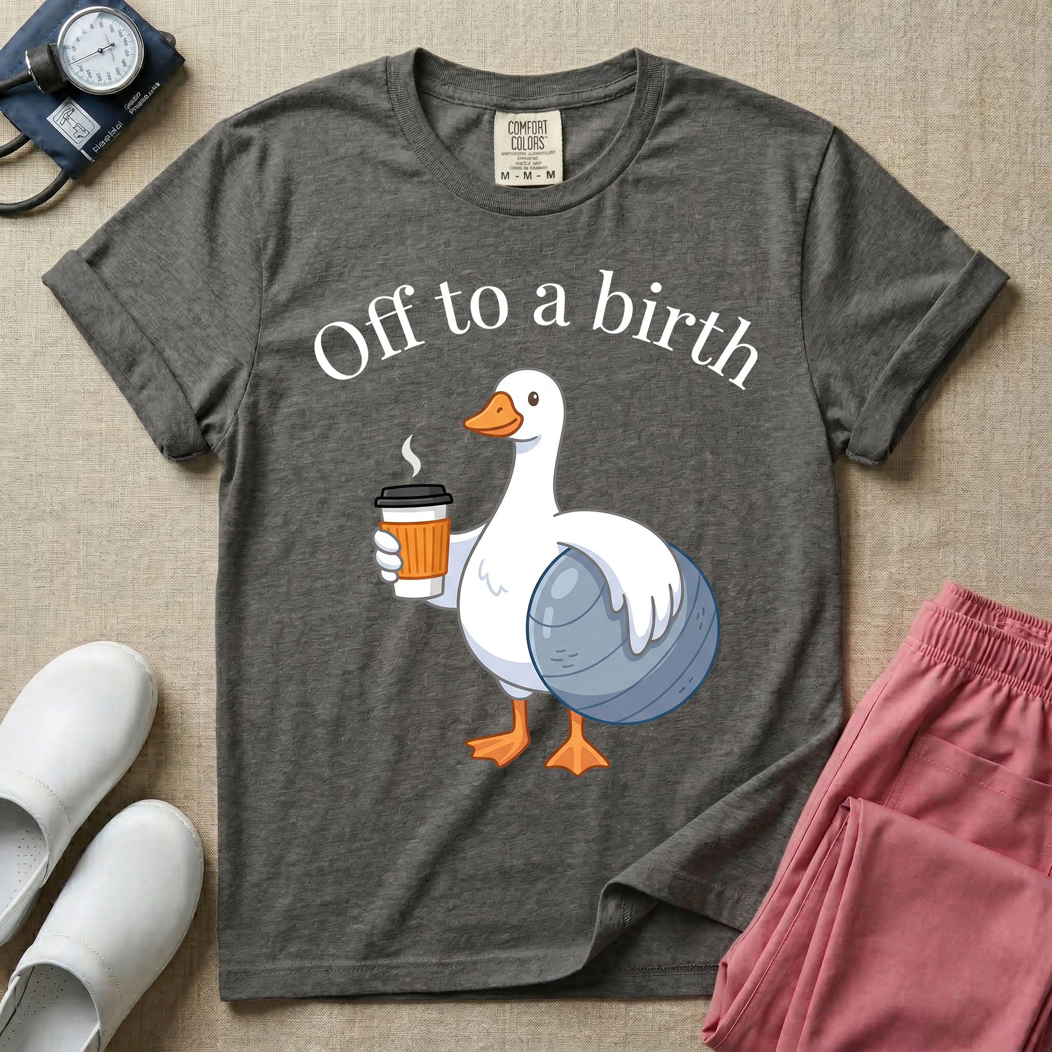 A humorous Labor and Delivery, Midwife, or Doula design featuring a cute cartoon white duck holding a steaming coffee cup and a birthing ball beneath the text "Off to a birth".