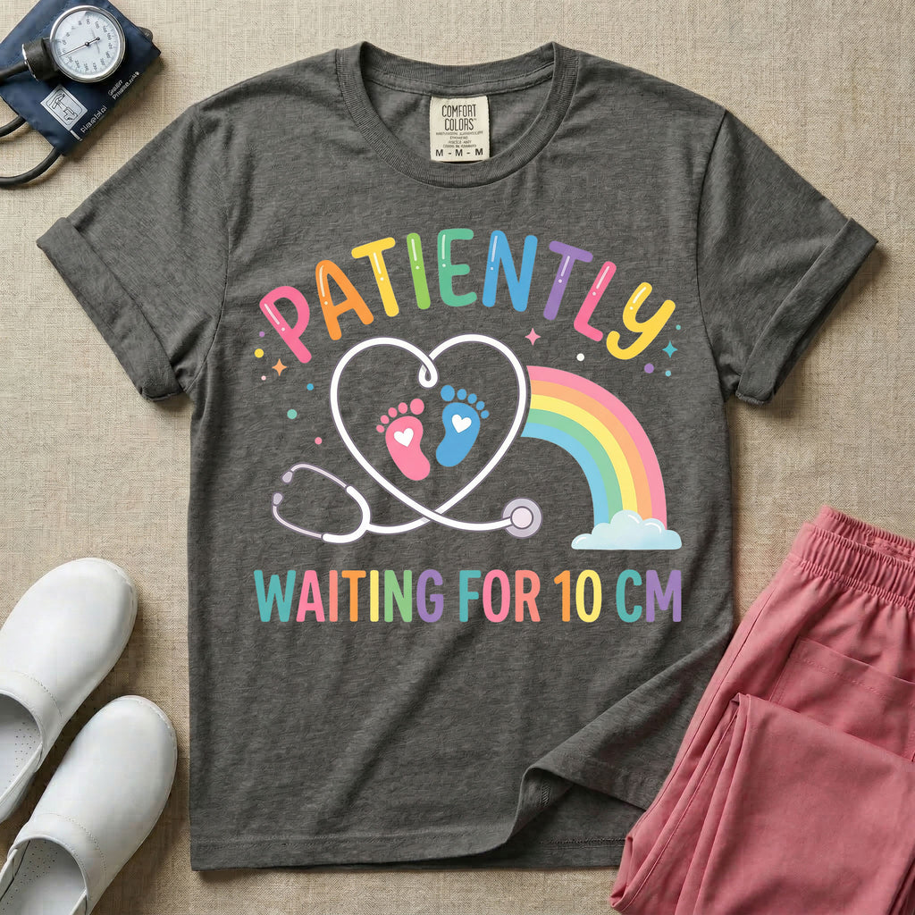 A cute Labor and Delivery and Midwife design featuring a heart-shaped stethoscope enclosing pink and blue baby footprints next to a pastel rainbow and small stars, accompanied by the text "PATIENTLY WAITING FOR 10 CM" in colorful lettering.