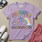 A cute Labor and Delivery and Midwife design featuring a heart-shaped stethoscope enclosing pink and blue baby footprints next to a pastel rainbow and small stars, accompanied by the text "PATIENTLY WAITING FOR 10 CM" in colorful lettering.