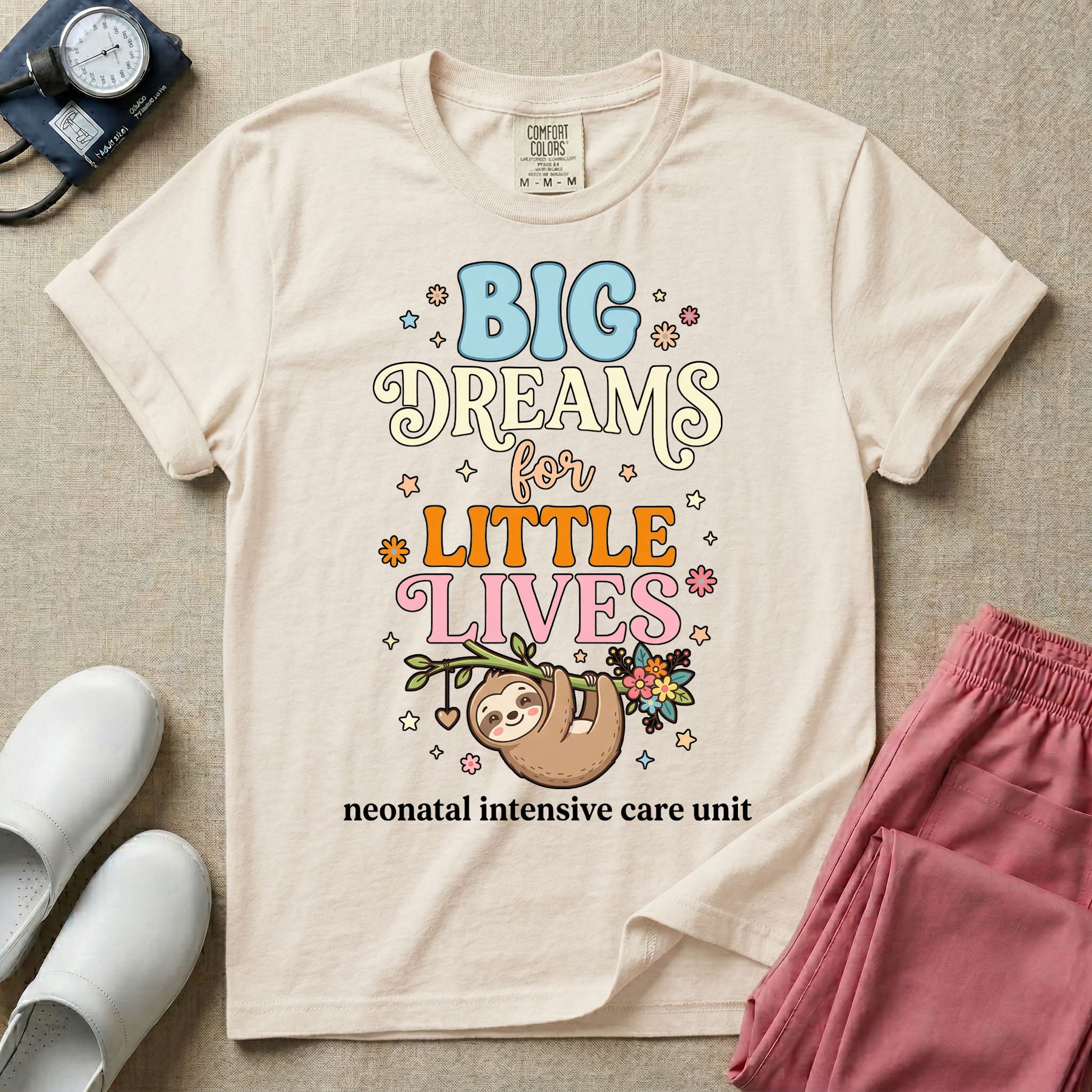 A cute Neonatal Intensive Care Unit nurse design featuring a smiling sloth hanging from a leafy branch decorated with colorful flowers and a dangling heart, surrounded by small stars, beneath the text "BIG Dreams for LITTLE LIVES neonatal intensive care unit" in varied, colorful typography.