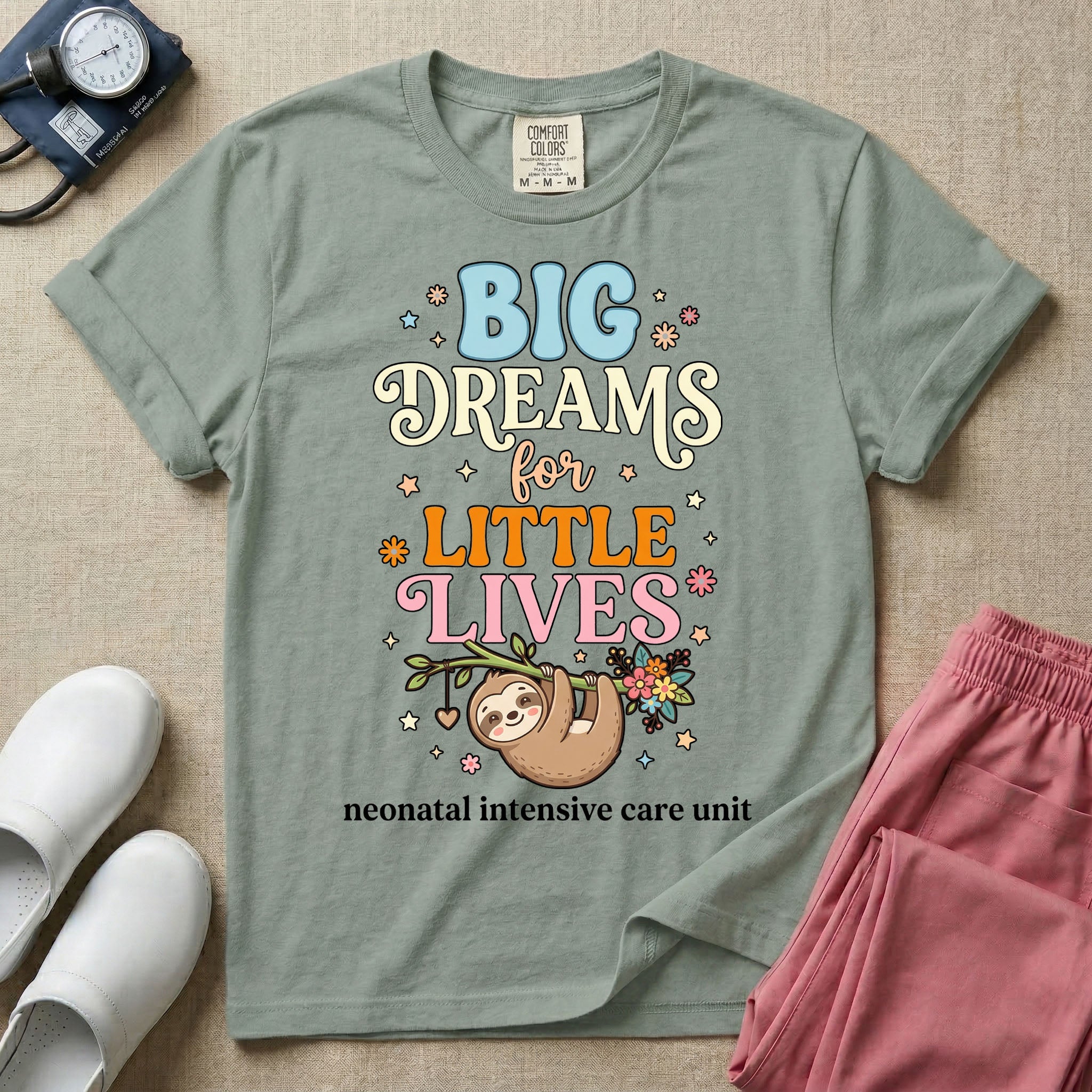 A cute Neonatal Intensive Care Unit nurse design featuring a smiling sloth hanging from a leafy branch decorated with colorful flowers and a dangling heart, surrounded by small stars, beneath the text "BIG Dreams for LITTLE LIVES neonatal intensive care unit" in varied, colorful typography.