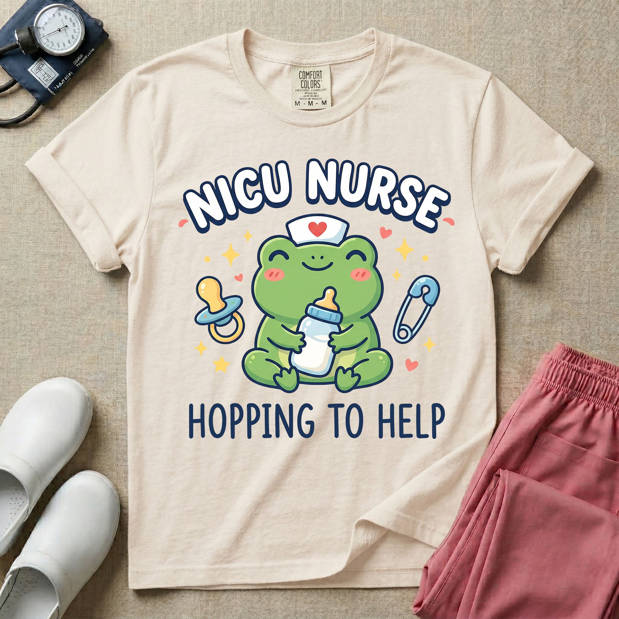 A cute Neonatal Intensive Care Unit nurse design featuring a smiling green frog wearing a nurse hat with a red heart, holding a baby bottle, accompanied by a floating pacifier, safety pin, stars, and hearts, surrounded by the text "NICU NURSE HOPPING TO HELP".