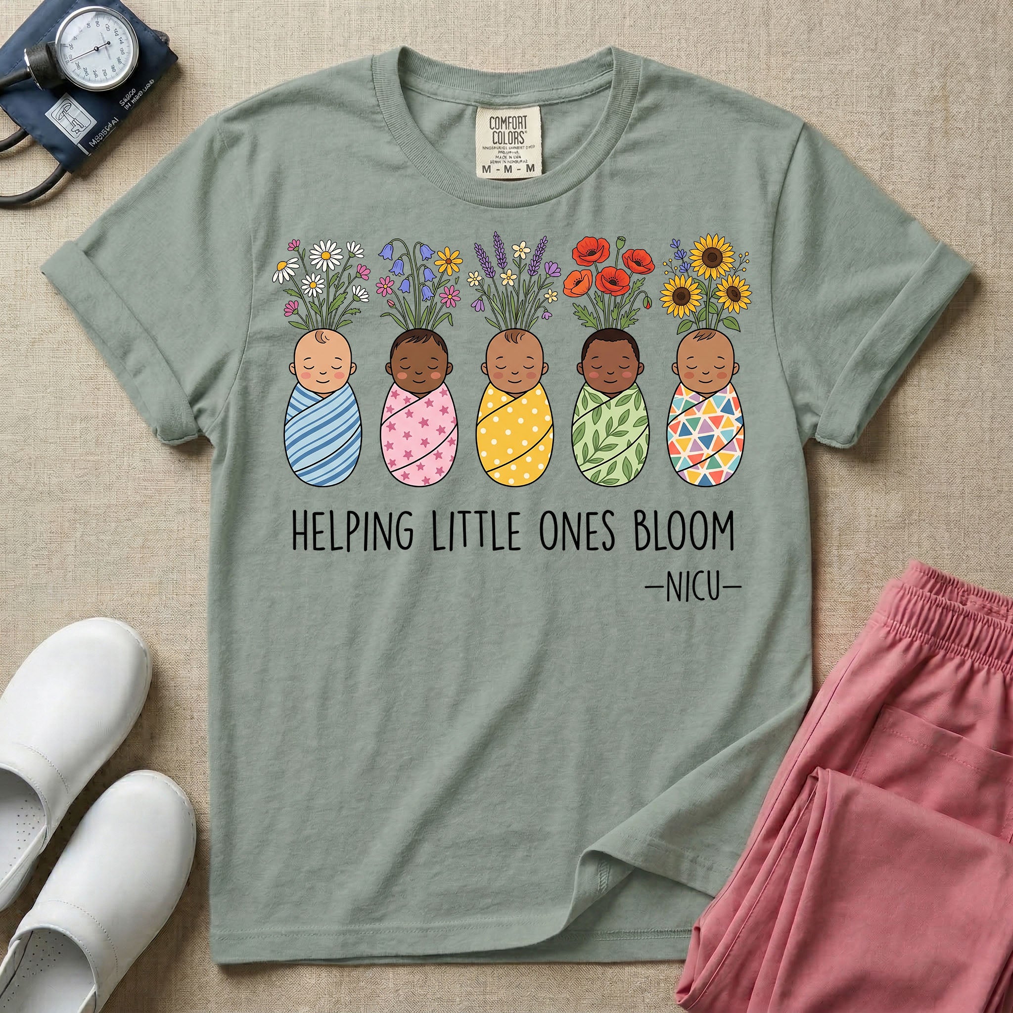 A Neonatal Intensive Care Unit nurse design featuring five peacefully sleeping, diverse babies in differently patterned swaddles with vibrant flowers like sunflowers and daisies blooming from the tops of their heads, positioned above the text "HELPING LITTLE ONES BLOOM -NICU-".