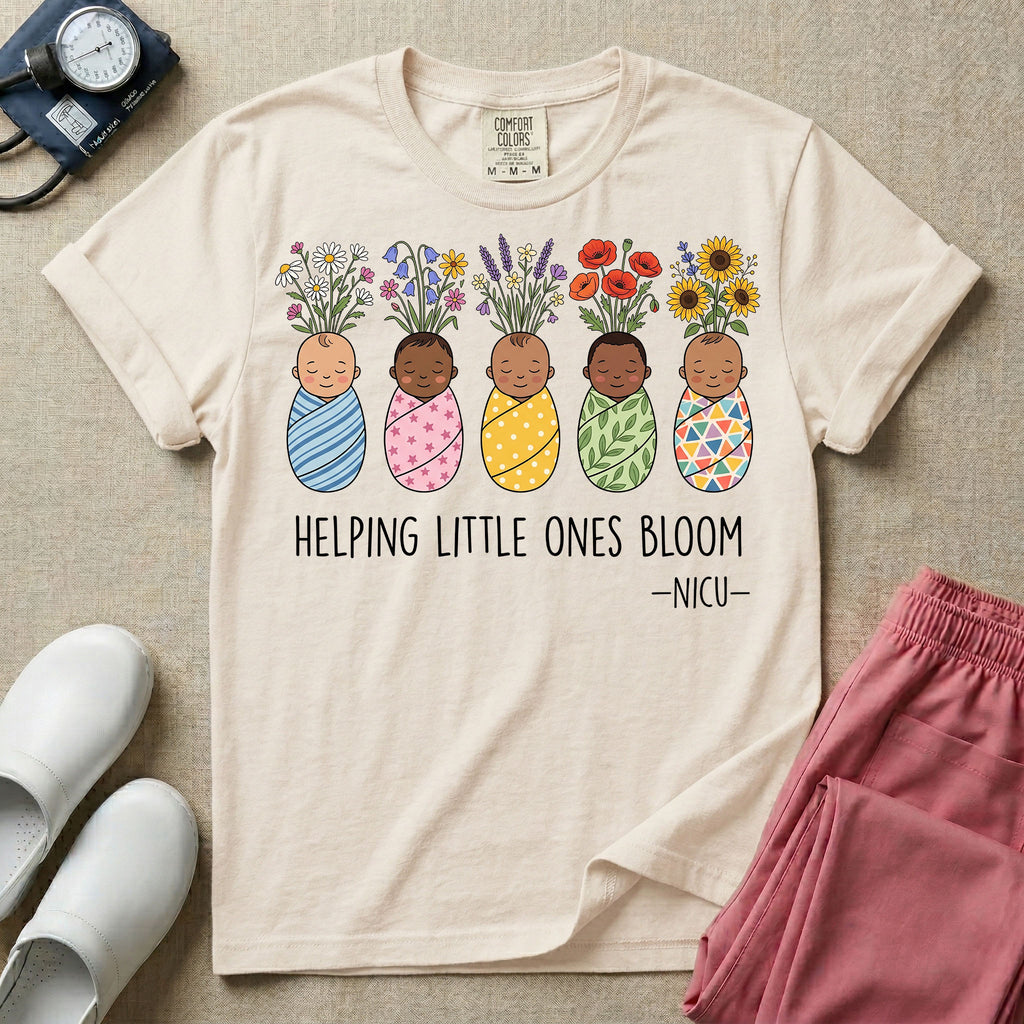 A Neonatal Intensive Care Unit nurse design featuring five peacefully sleeping, diverse babies in differently patterned swaddles with vibrant flowers like sunflowers and daisies blooming from the tops of their heads, positioned above the text "HELPING LITTLE ONES BLOOM -NICU-".