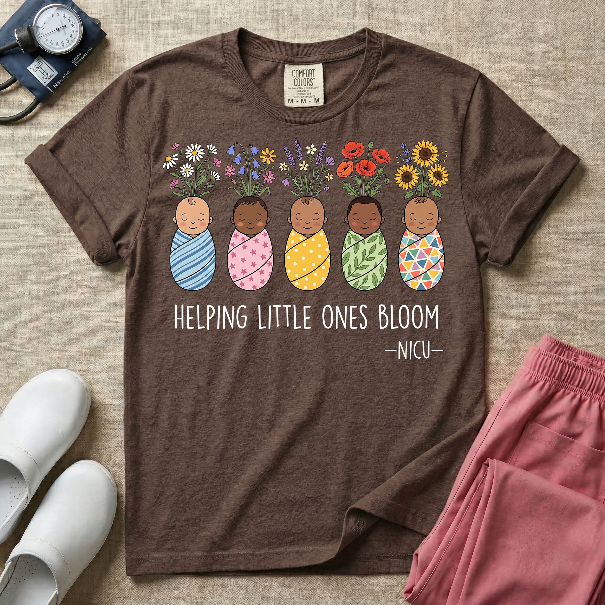 A Neonatal Intensive Care Unit nurse design featuring five peacefully sleeping, diverse babies in differently patterned swaddles with vibrant flowers like sunflowers and daisies blooming from the tops of their heads, positioned above the text "HELPING LITTLE ONES BLOOM -NICU-".