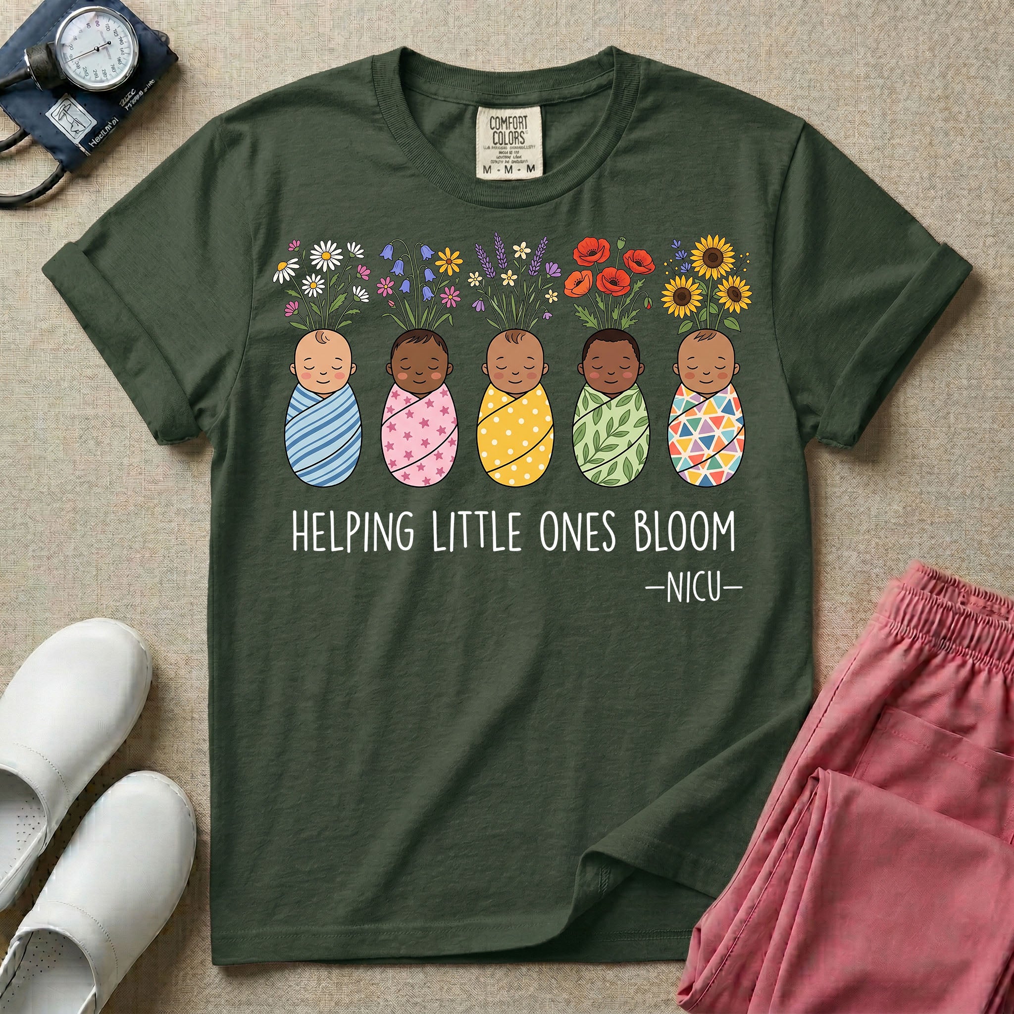 A Neonatal Intensive Care Unit nurse design featuring five peacefully sleeping, diverse babies in differently patterned swaddles with vibrant flowers like sunflowers and daisies blooming from the tops of their heads, positioned above the text "HELPING LITTLE ONES BLOOM -NICU-".