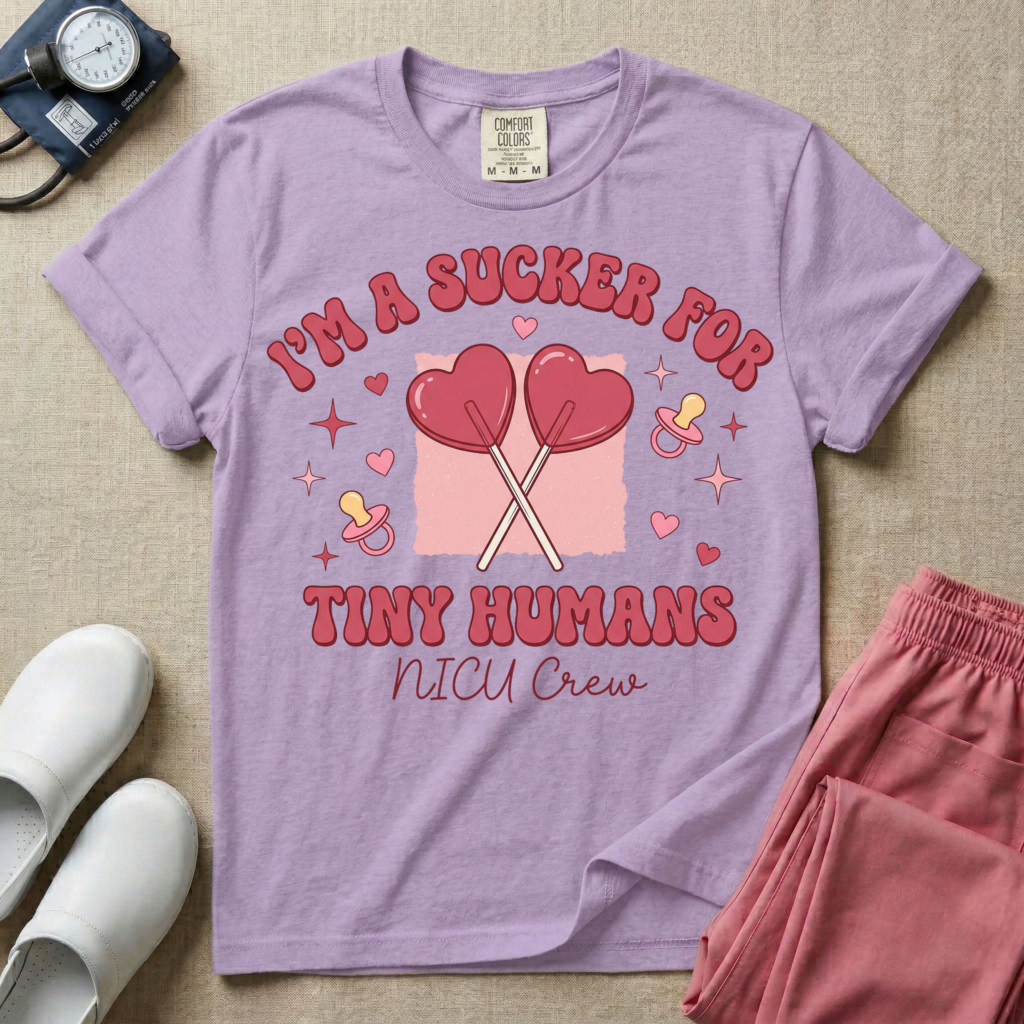 A retro Neonatal Intensive Care Unit nurse design featuring two crossed heart-shaped lollipops over a textured pink square, flanked by two baby pacifiers, sparkling stars, and small hearts, surrounded by the humorous text "I'M A SUCKER FOR TINY HUMANS NICU Crew" in a red and pink groovy font.