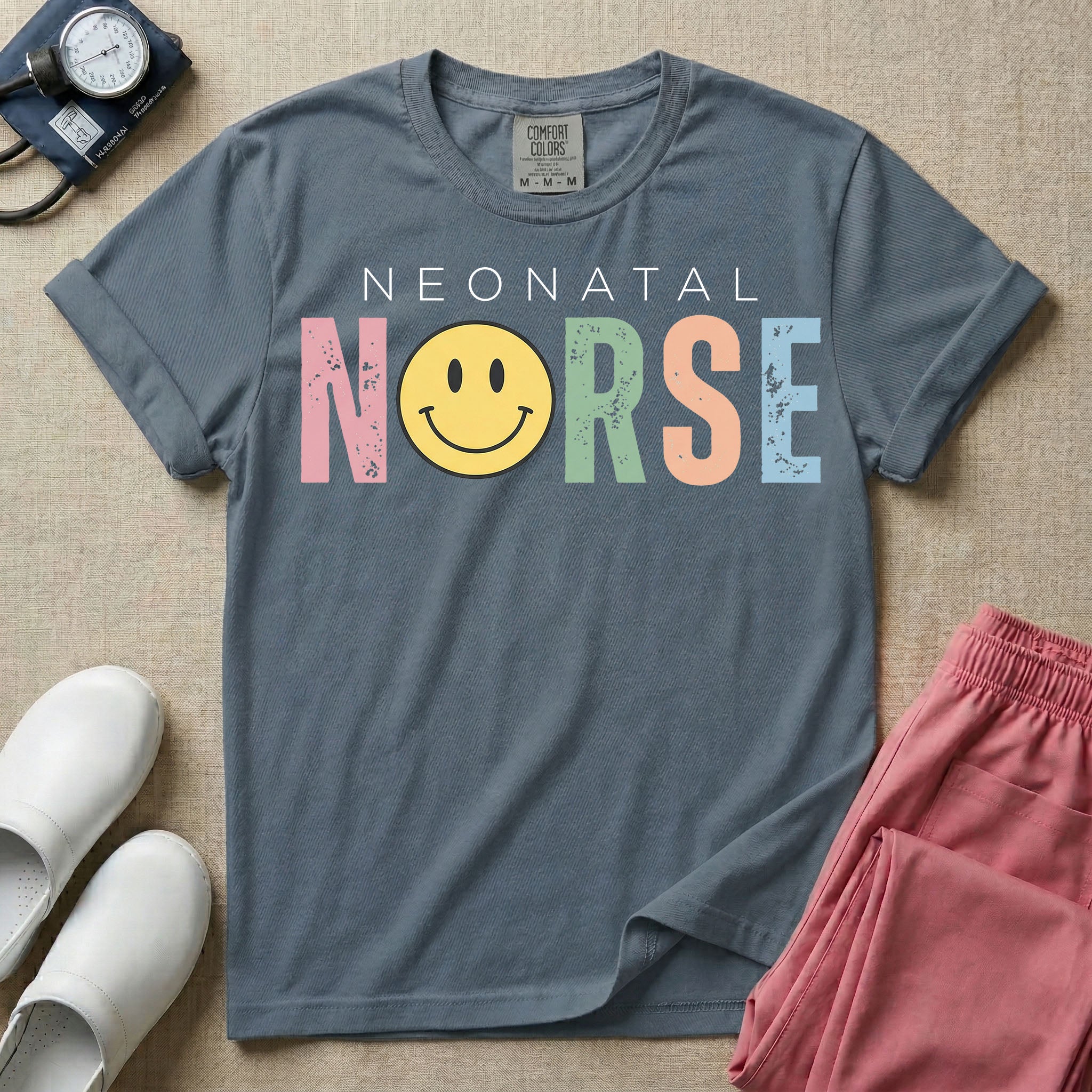 A retro Neonatal Intensive Care Unit nurse design featuring the word "NEONATAL" in simple white lettering above the word "NURSE" spelled out in large, distressed, pastel-colored letters, with a classic yellow smiley face replacing the letter U.
