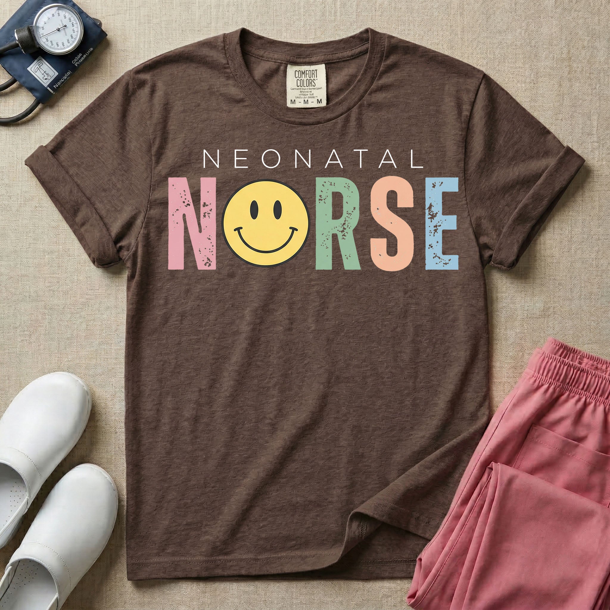 A retro Neonatal Intensive Care Unit nurse design featuring the word "NEONATAL" in simple white lettering above the word "NURSE" spelled out in large, distressed, pastel-colored letters, with a classic yellow smiley face replacing the letter U.