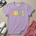 A retro Neonatal Intensive Care Unit nurse design featuring the word "NEONATAL" in simple white lettering above the word "NURSE" spelled out in large, distressed, pastel-colored letters, with a classic yellow smiley face replacing the letter U.