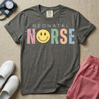 A retro Neonatal Intensive Care Unit nurse design featuring the word "NEONATAL" in simple white lettering above the word "NURSE" spelled out in large, distressed, pastel-colored letters, with a classic yellow smiley face replacing the letter U.