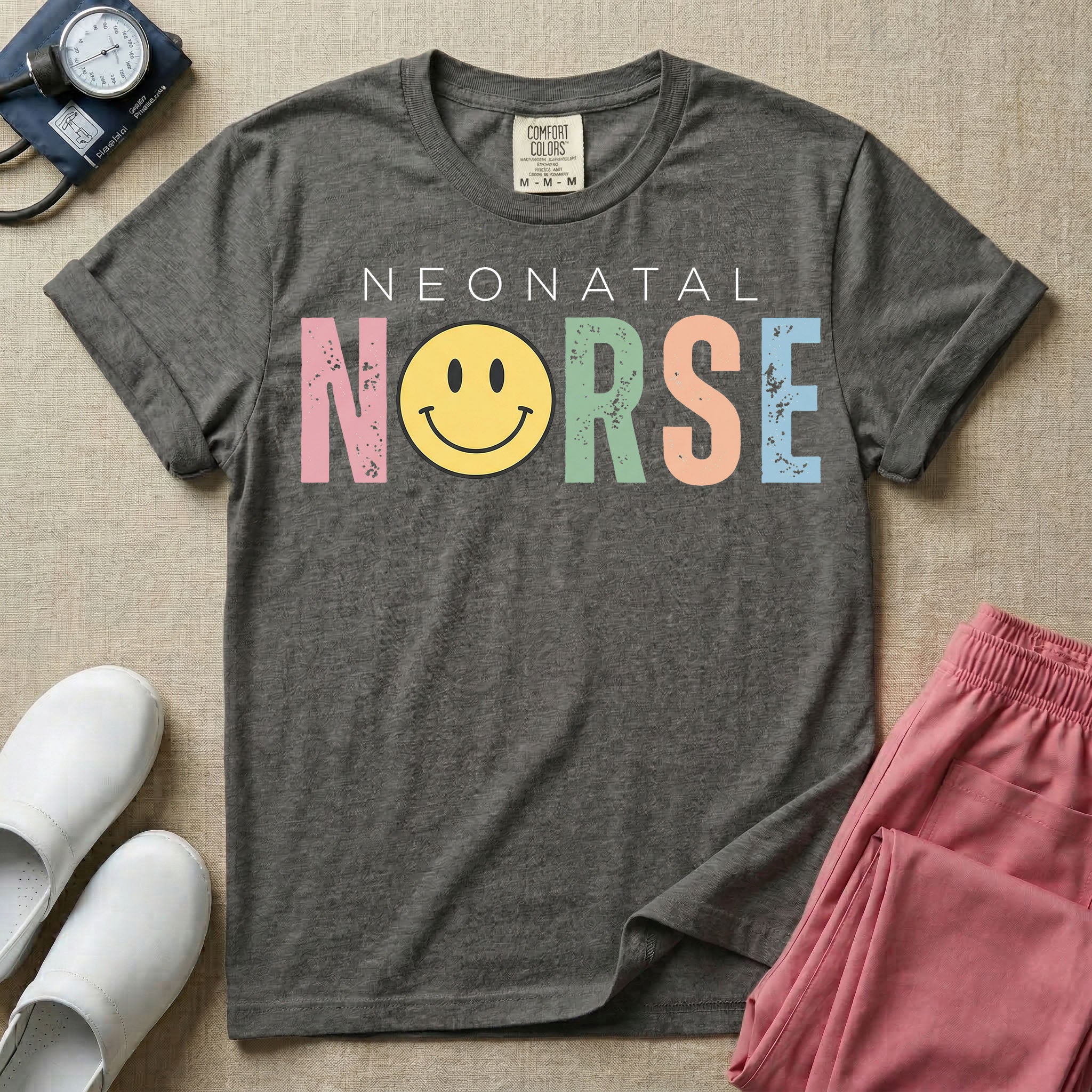 A retro Neonatal Intensive Care Unit nurse design featuring the word "NEONATAL" in simple white lettering above the word "NURSE" spelled out in large, distressed, pastel-colored letters, with a classic yellow smiley face replacing the letter U.