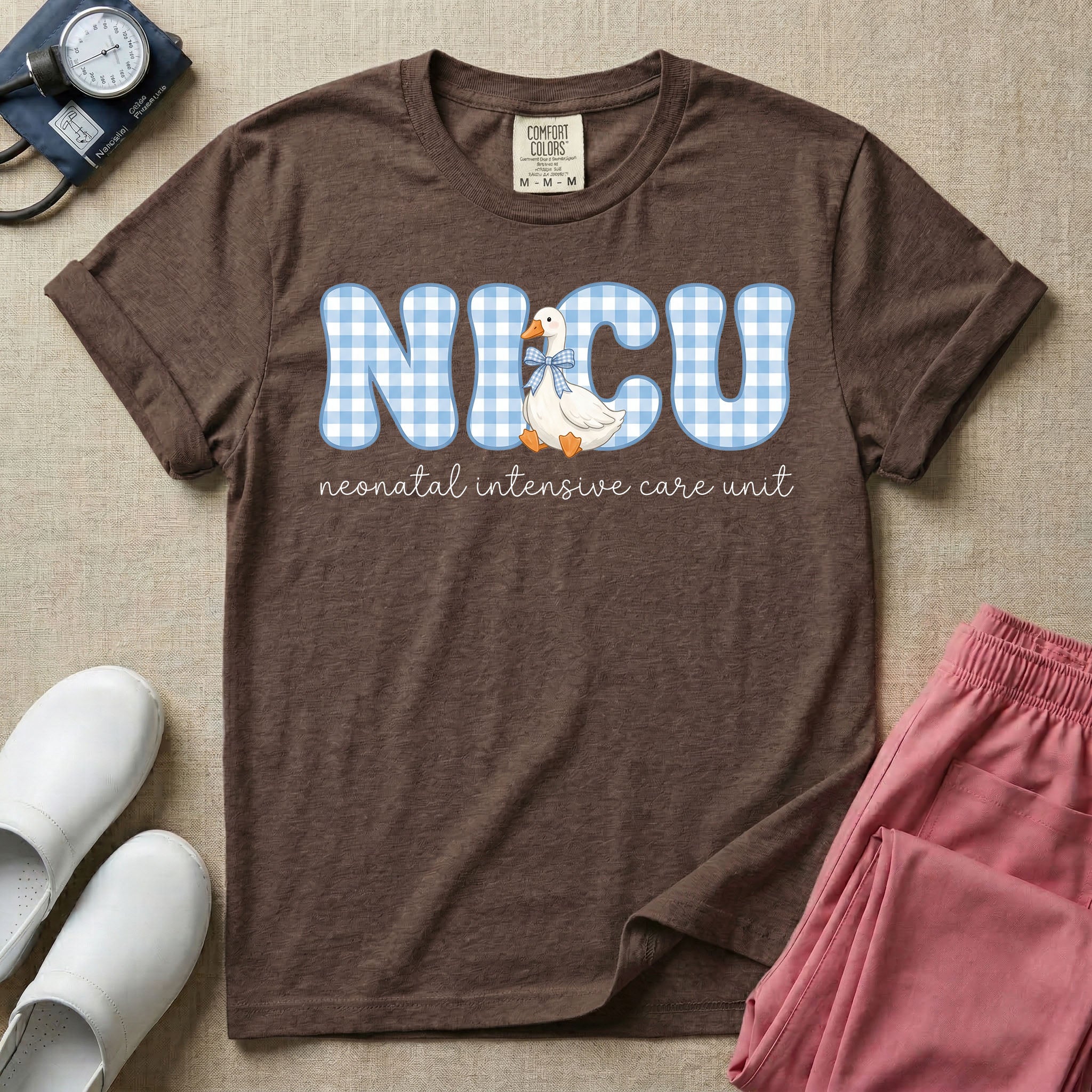 A cute Neonatal Intensive Care Unit nurse design featuring large blue and white gingham patterned letters spelling NICU, alongside a sweet white duck wearing a matching blue patterned bow, positioned above the text "neonatal intensive care unit" in a delicate cursive font.