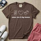 A t-shirt featuring minimalist line art of a peace sign, a heart, and baby footprints above the text "peace, love & tiny humans" designed for NICU, labor and delivery, and pediatric nurses.