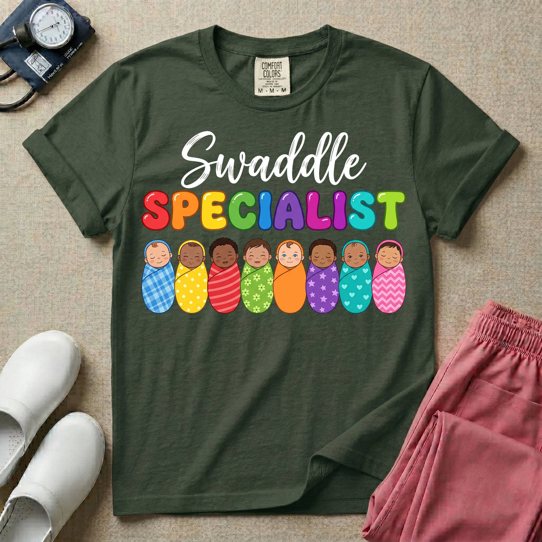 A graphic featuring the word Swaddle in white cursive above the word SPECIALIST in bright, colorful bubble letters, resting over a row of eight diverse babies wrapped in colorful patterned swaddles, designed for NICU, labor and delivery, postpartum, and pediatric nurses.