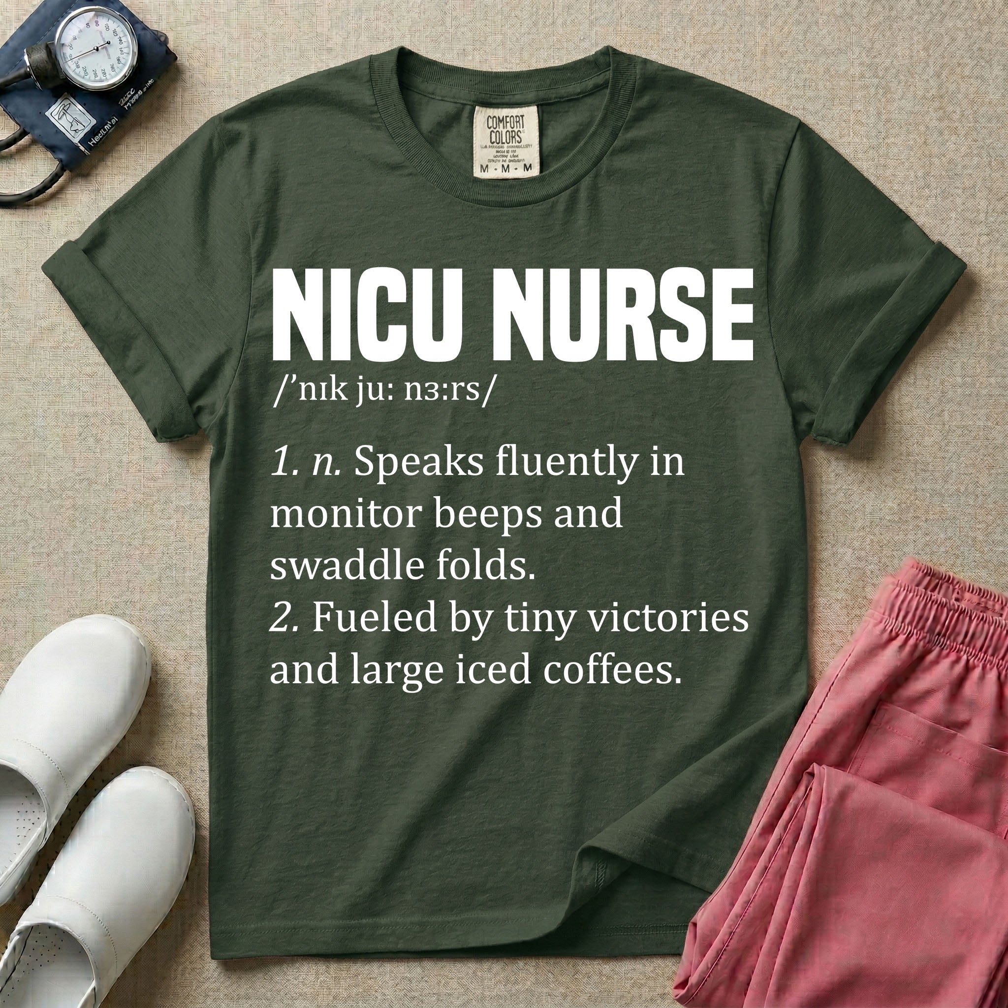 A graphic featuring a dictionary definition style layout with the bold heading NICU NURSE, followed by the phonetic pronunciation and two humorous definitions reading "1. n. Speaks fluently in monitor beeps and swaddle folds." and "2. Fueled by tiny victories and large iced coffees." in white text.