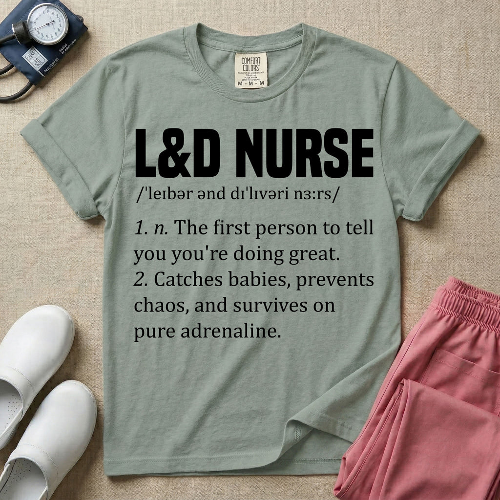 A graphic featuring a dictionary definition style layout with the bold heading L&D NURSE, followed by the phonetic pronunciation and two humorous definitions reading "1. n. The first person to tell you you're doing great." and "2. Catches babies, prevents chaos, and survives on pure adrenaline." in white text, designed for labor and delivery nurses.