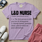 A graphic featuring a dictionary definition style layout with the bold heading L&D NURSE, followed by the phonetic pronunciation and two humorous definitions reading "1. n. The first person to tell you you're doing great." and "2. Catches babies, prevents chaos, and survives on pure adrenaline." in white text, designed for labor and delivery nurses.